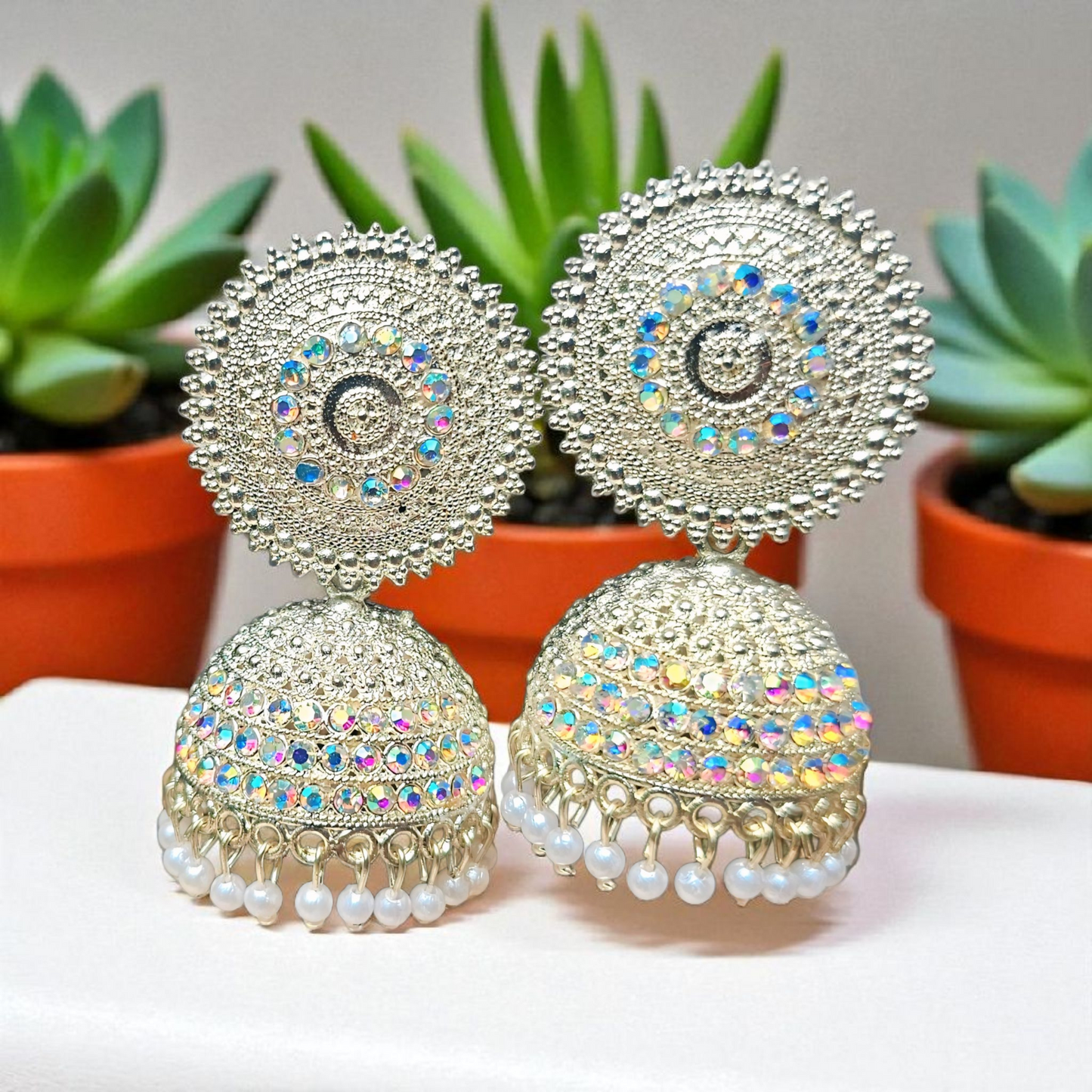Bell-shaped jhumka adorned with shimmering stones ✨